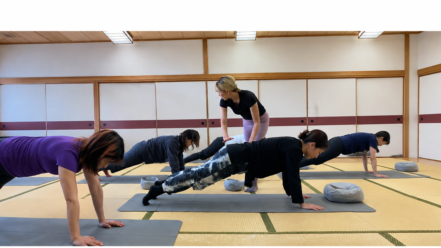 東京都北区で開催しているKAMIYA Club Pilatesのレッスン風景。和室でインストラクターが参加者のプランク姿勢をサポートしながら、体幹を鍛えるピラティスを行っている。